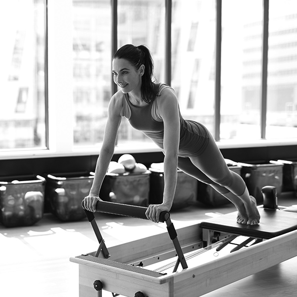 Woman in a pilates reformer class