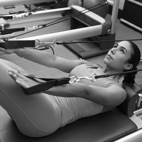 Woman in a pilates reformer class