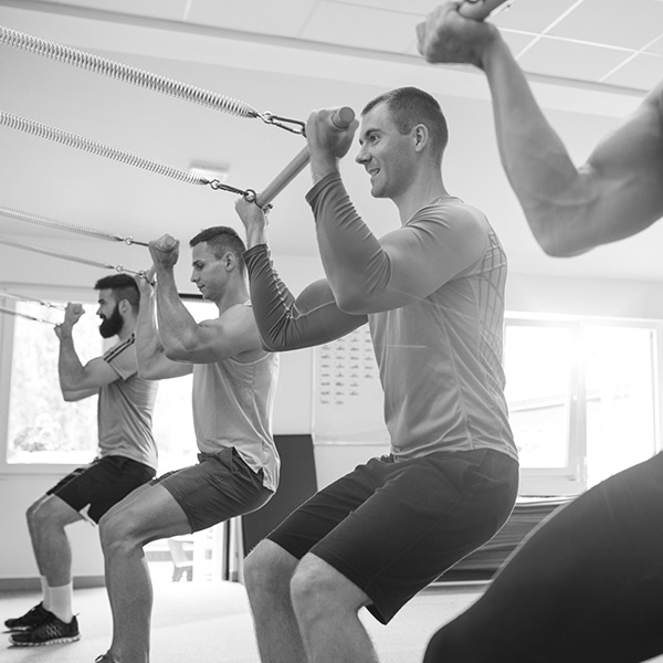 group of men angling bodies and doing pilates